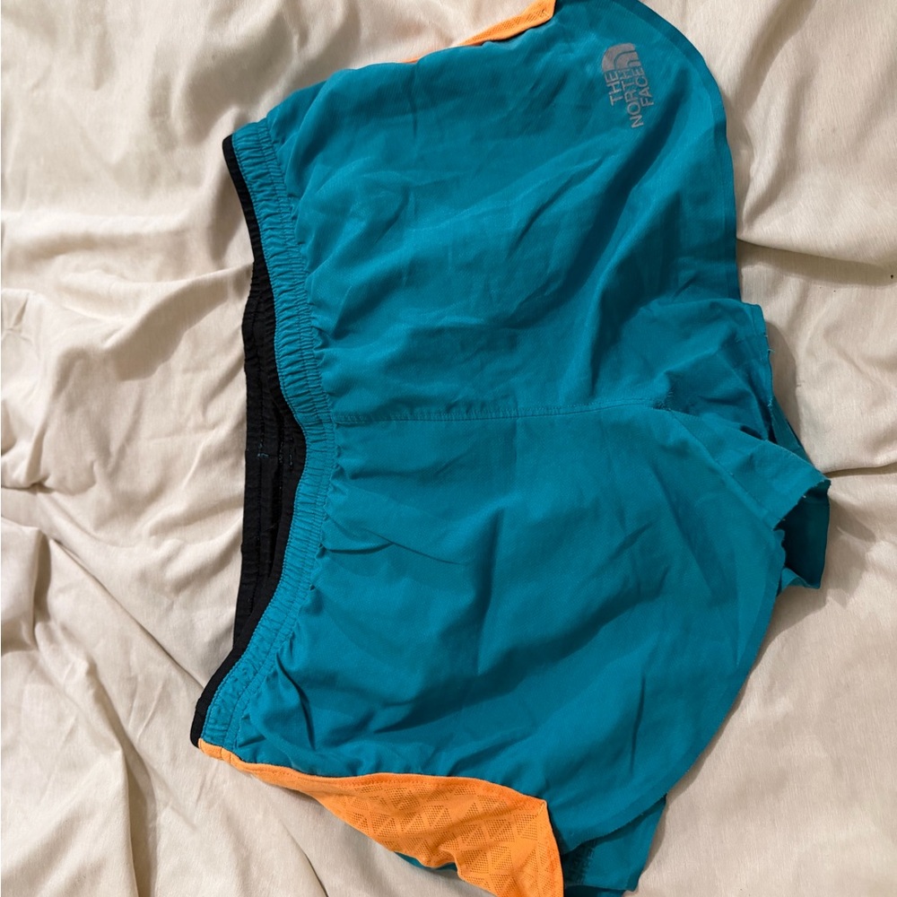The North Face Teal Running Shorts with Orange Accents